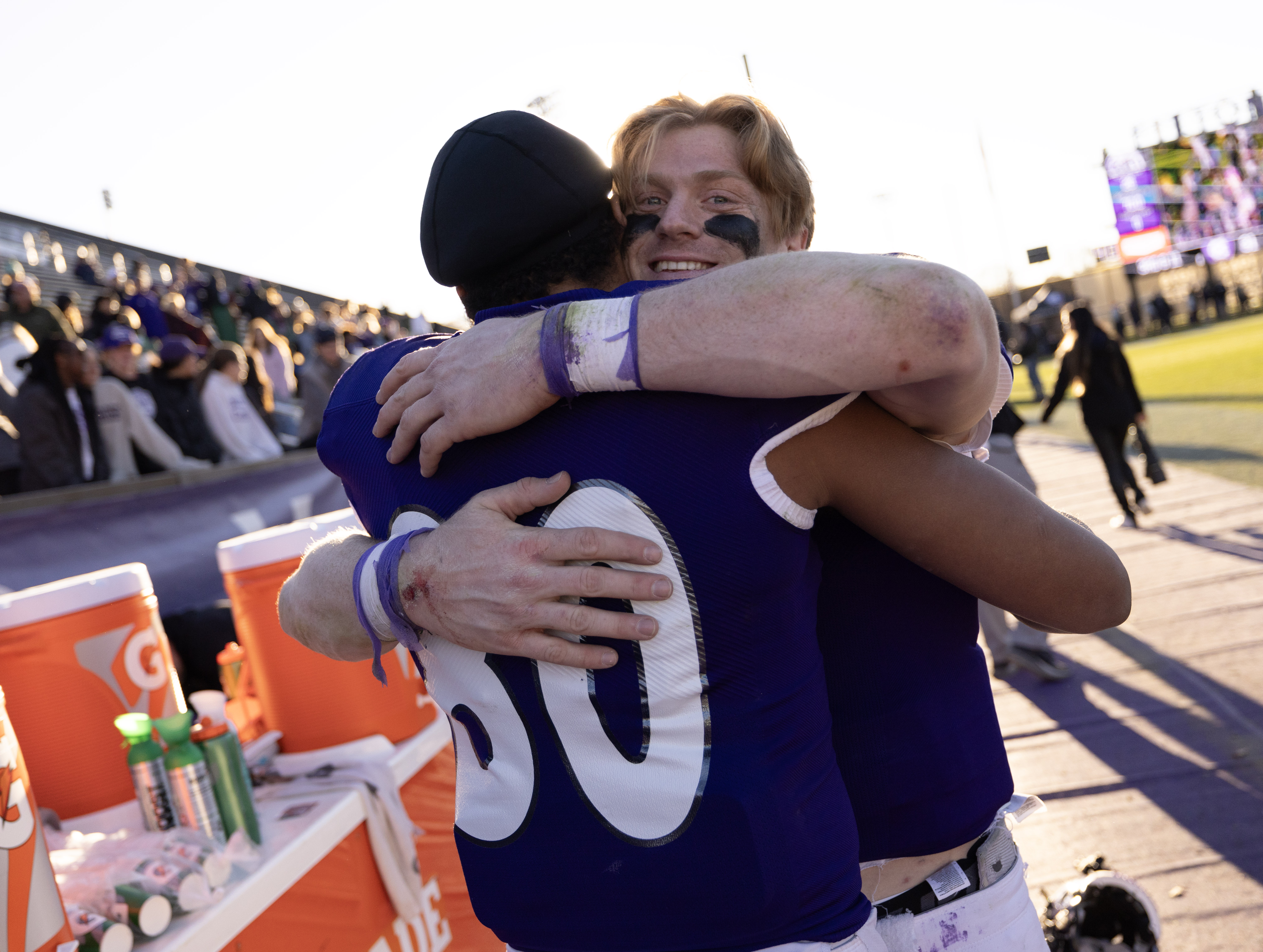 Two football players hug at the end of the game