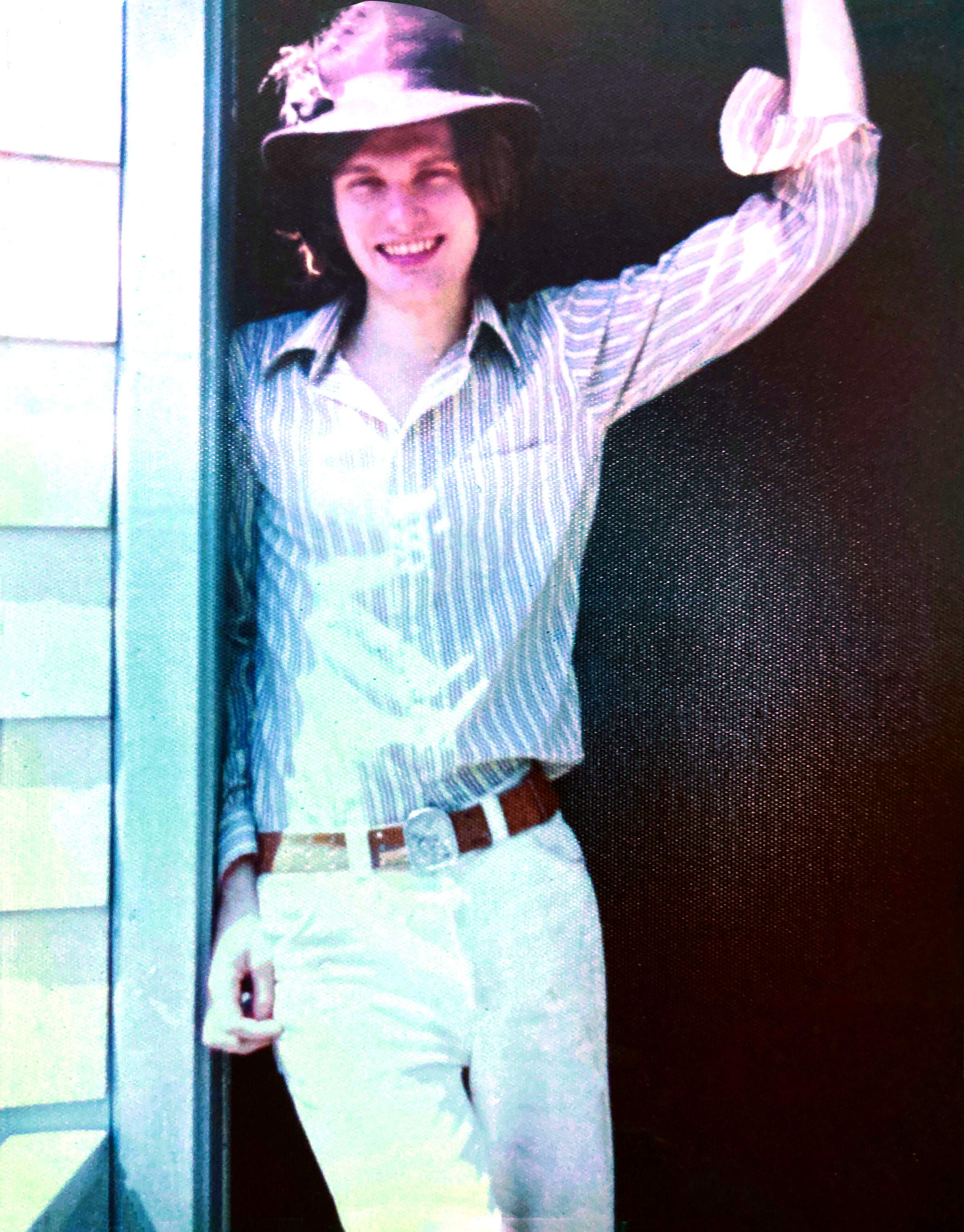 Man in hat stands in doorway