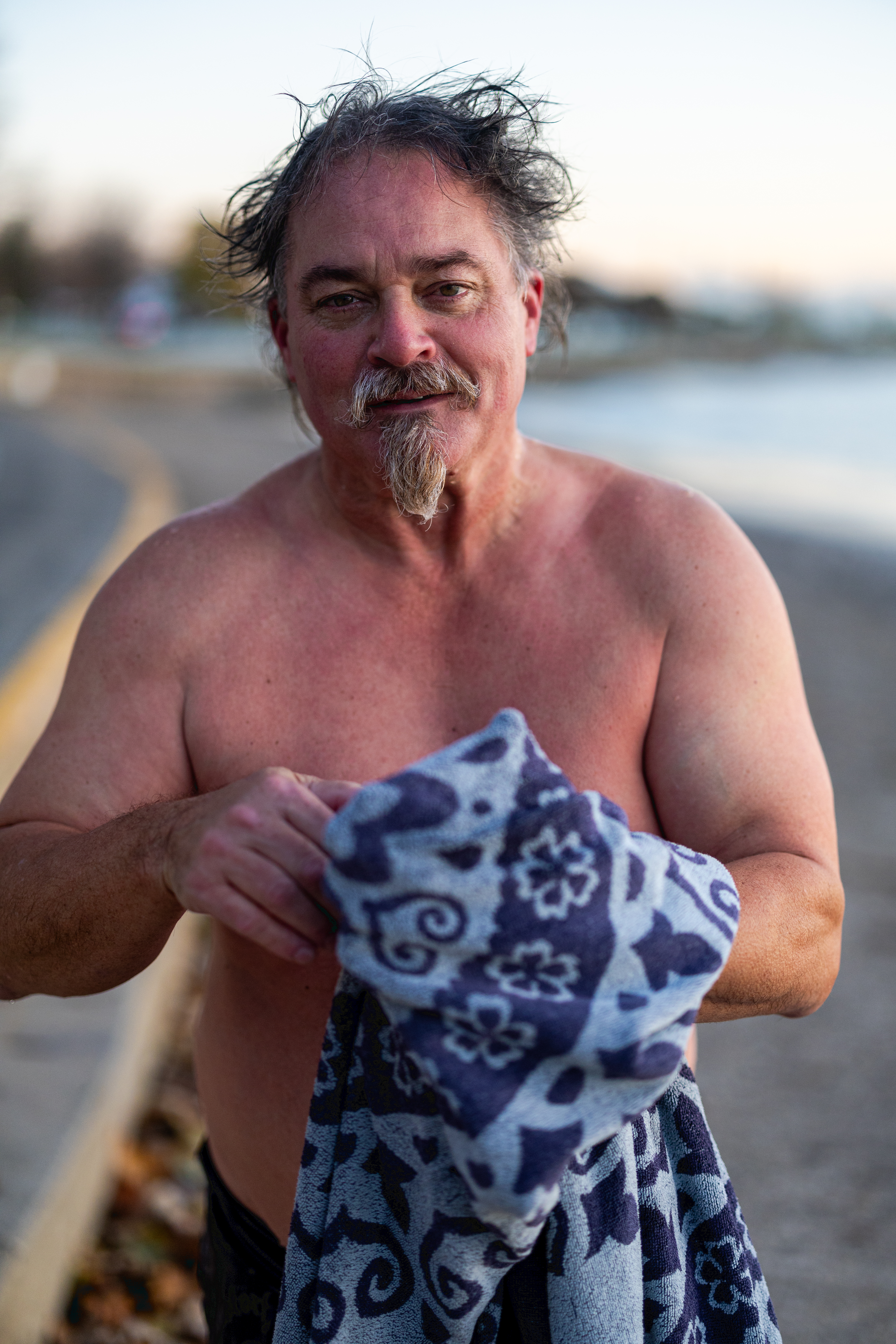 Man in bathing suit holding towel