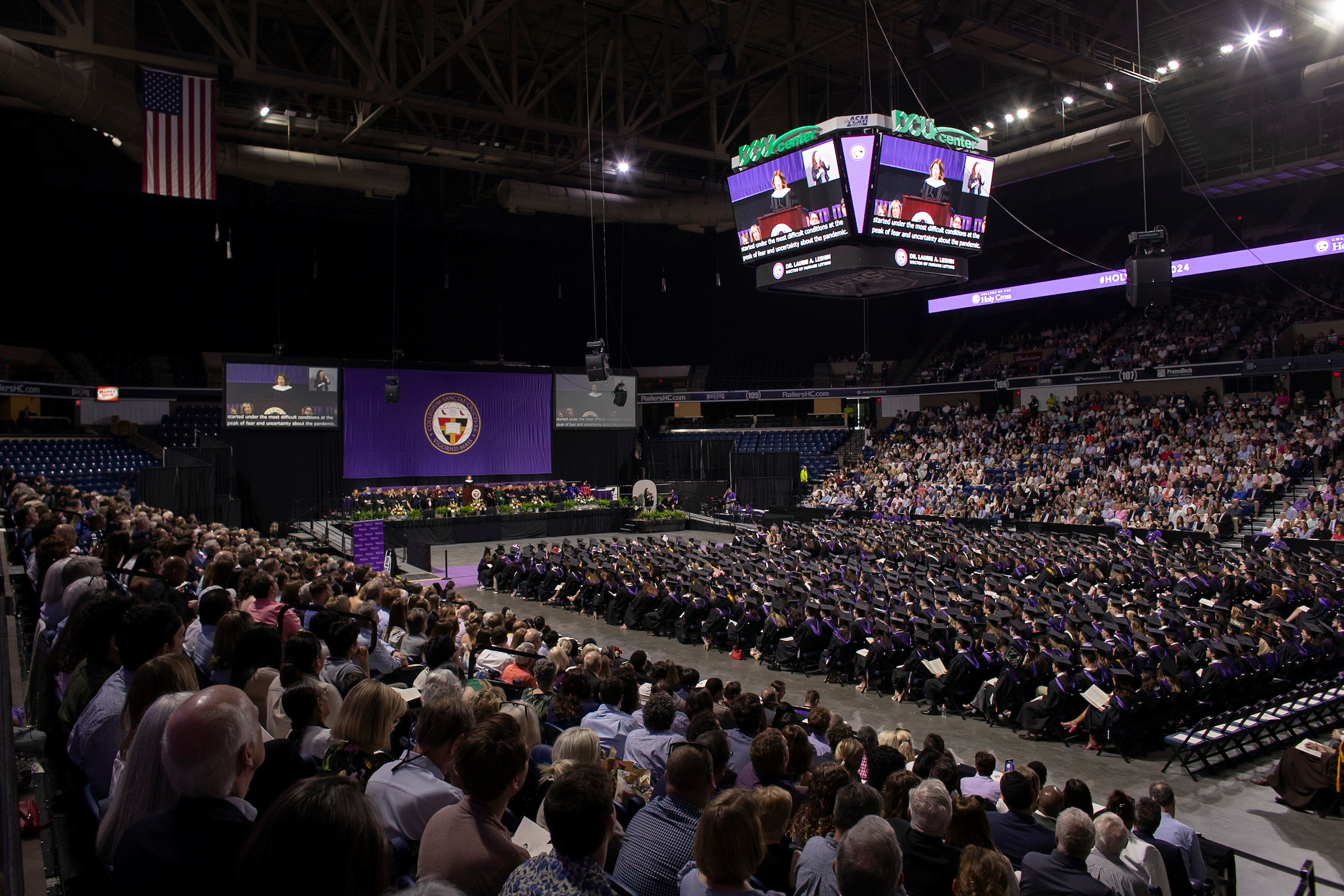 Overall view of a commencement ceremony in a large arena.