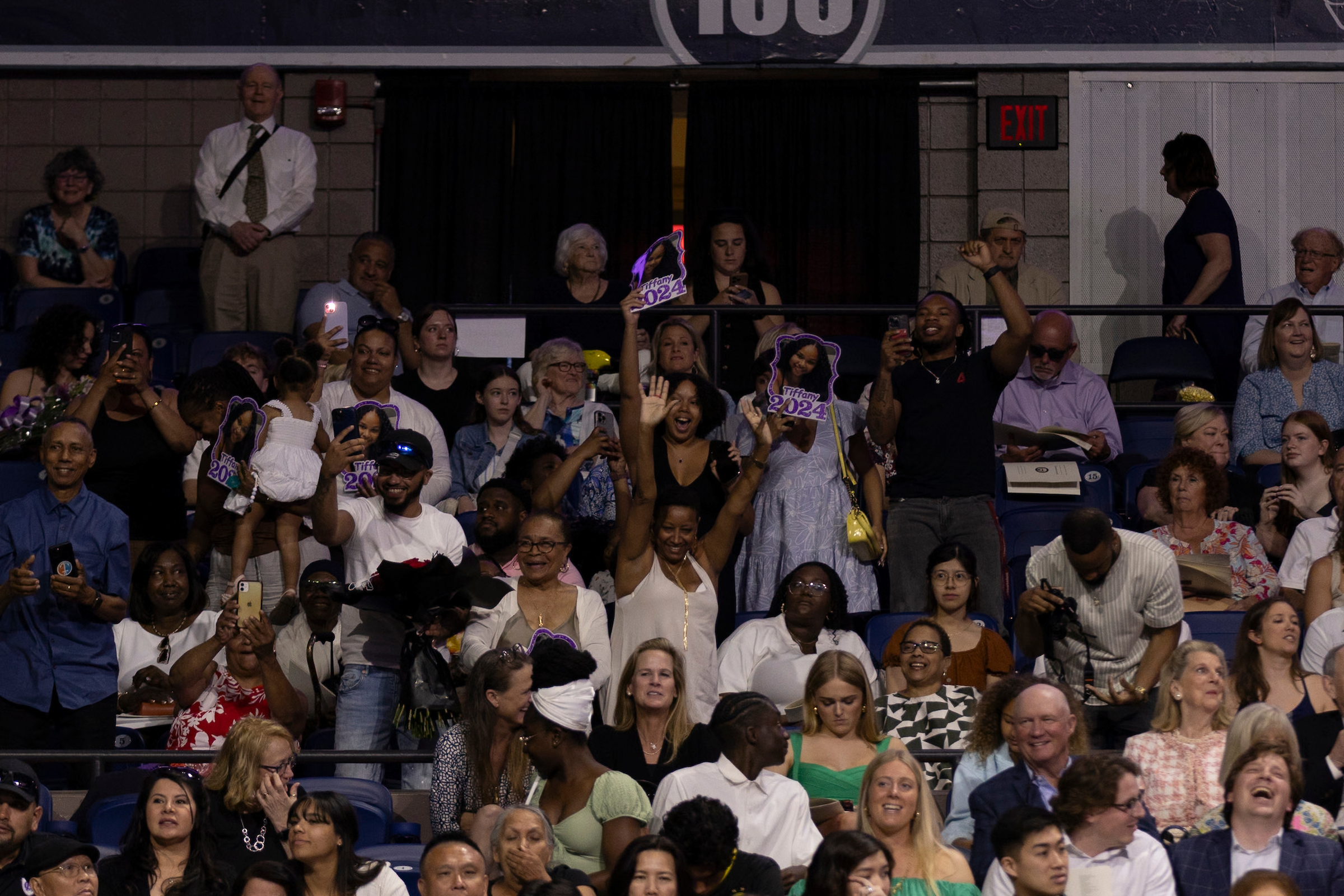 Families cheer on graduates during commencement ceremony.
