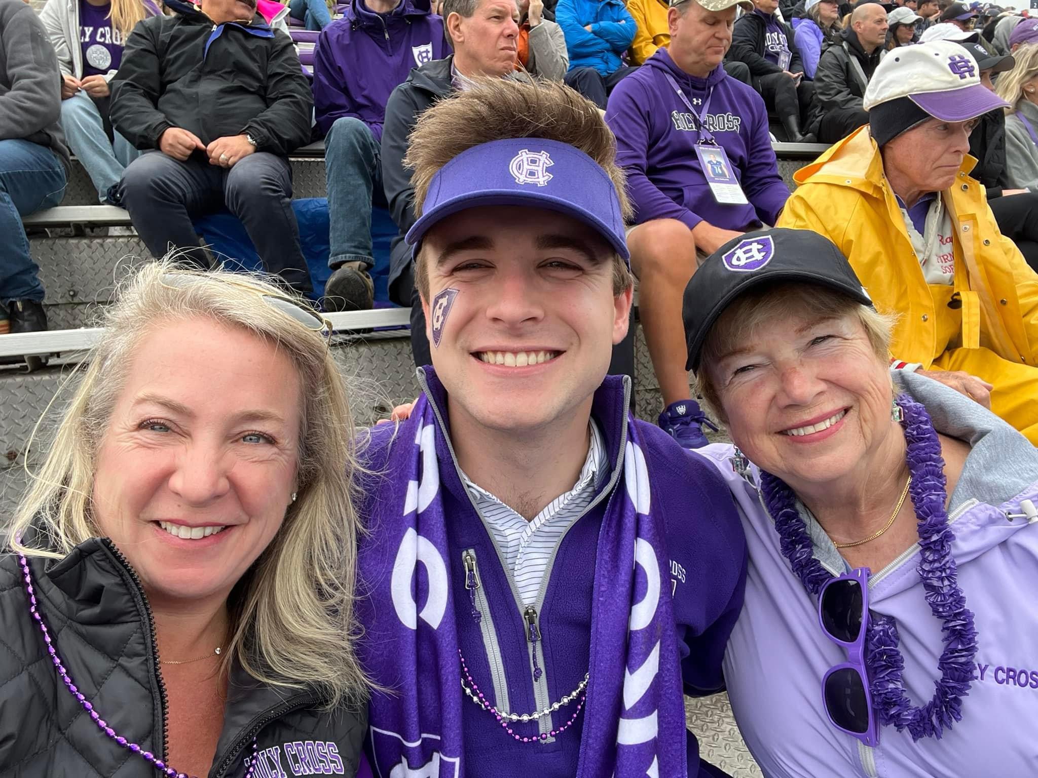 Kevin Hamilton surrounded by his mother and grandmother at a football game