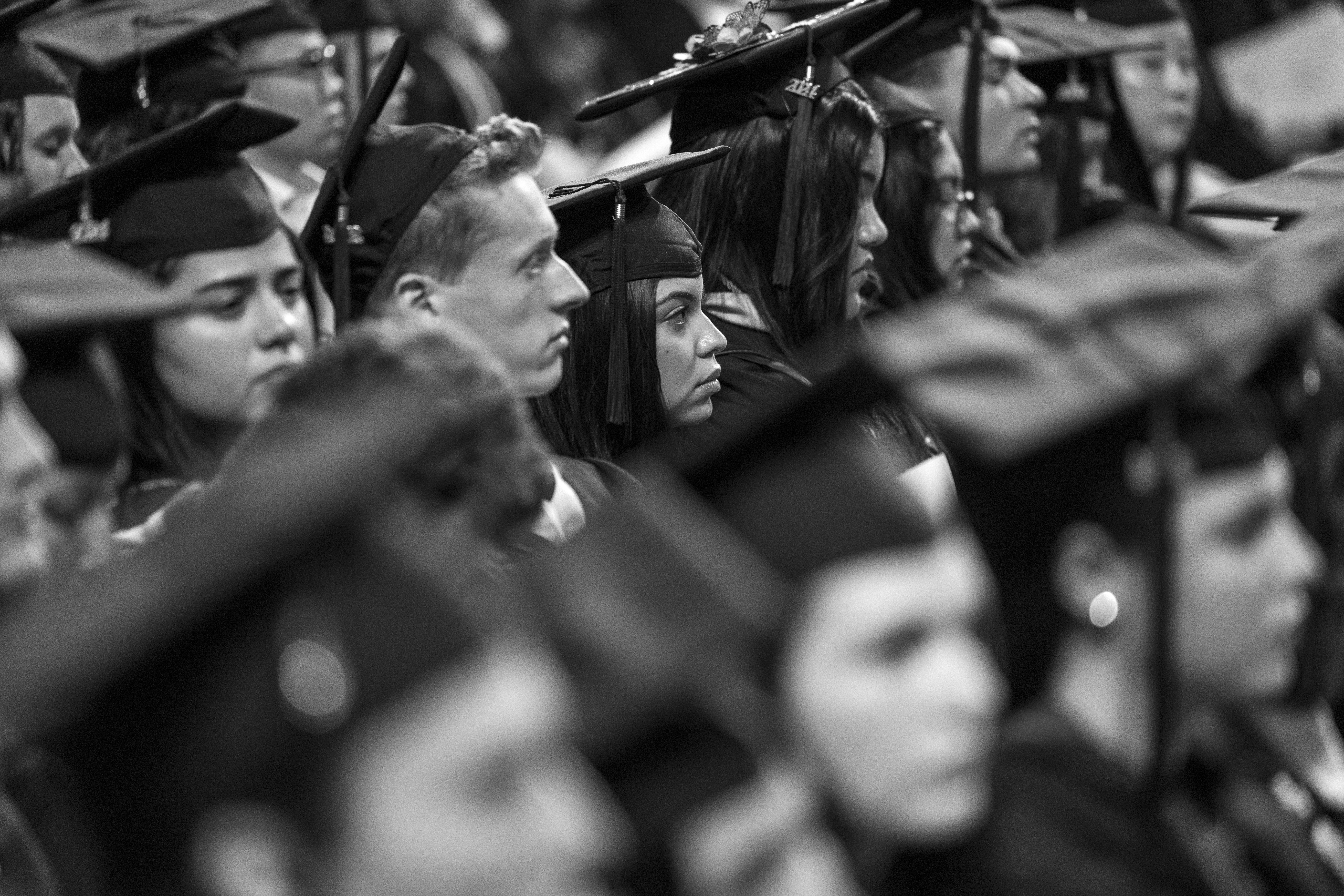 Graduates listen to speakers during commencement