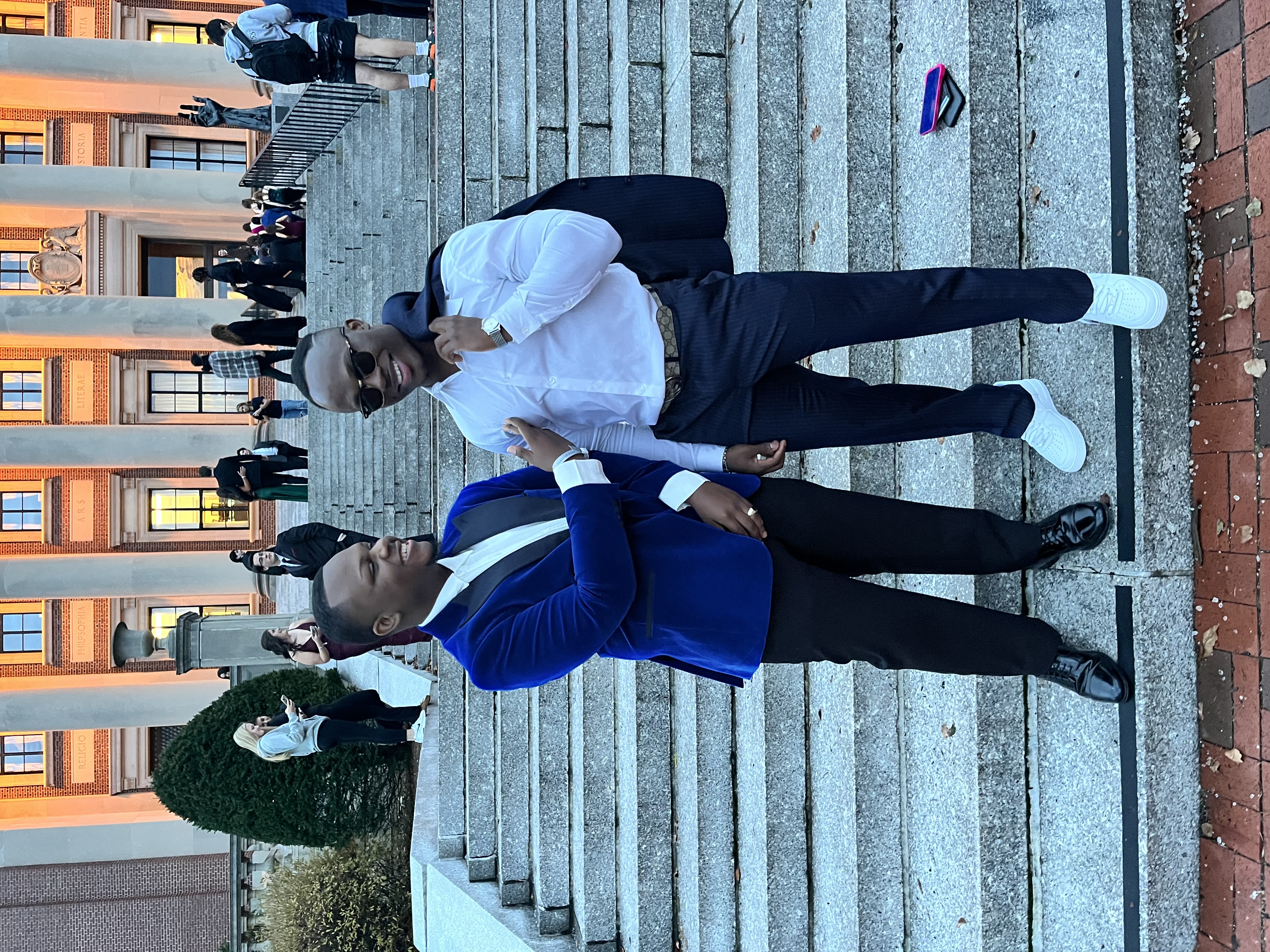 Two young men standing on the bottom steps of Dinand Libary