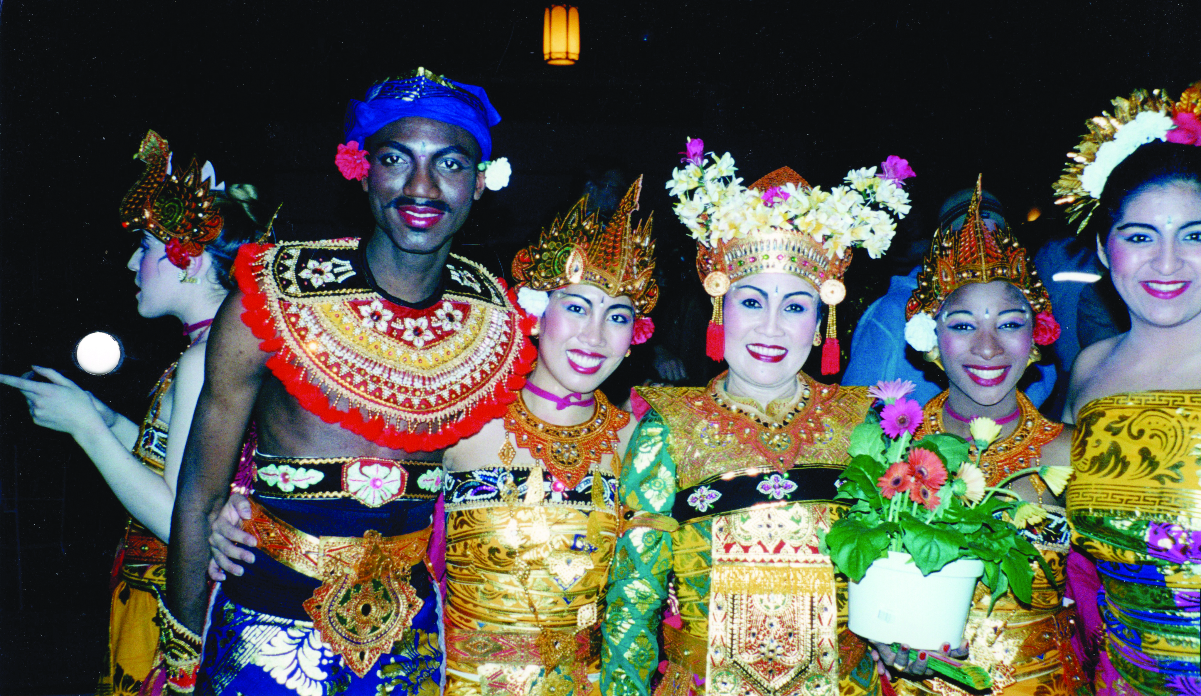 A group of people standing shoulder-to-should in Balinese regalia