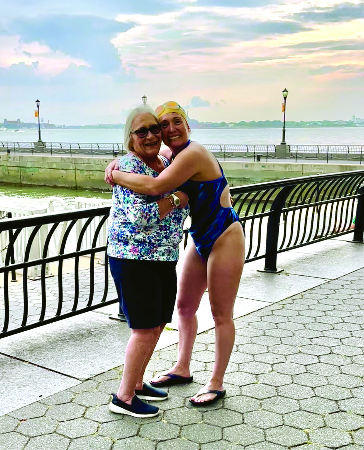Woman in bathing suit hugs woman