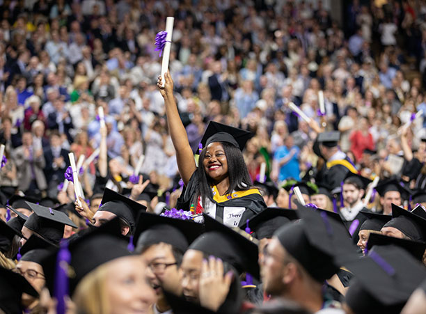 A student celebrates after receiving their diploma.