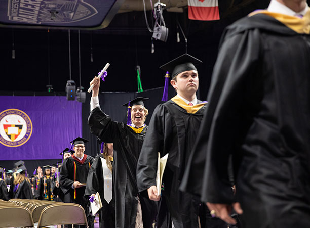A student celebrates after receiving their diploma.