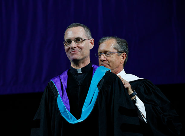 Rev. Sean Carroll, S.J., the executive director of the Kino Border Initiative, receives an honorary degree.