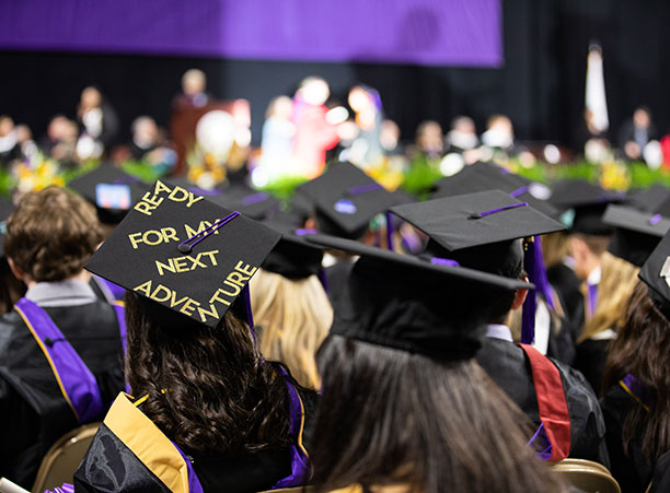 A student wears a decorated mortarboard.