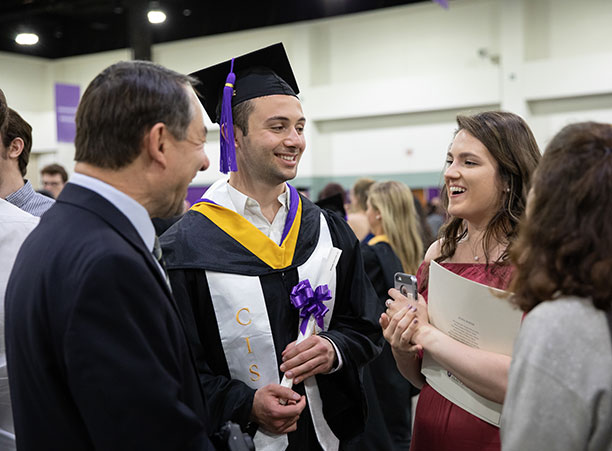 Students celebrate with their friends and family at the reception following the ceremony.