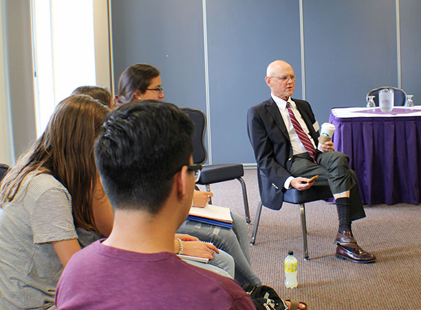 Ned Weyman addresses a group of students in a separate discussion.