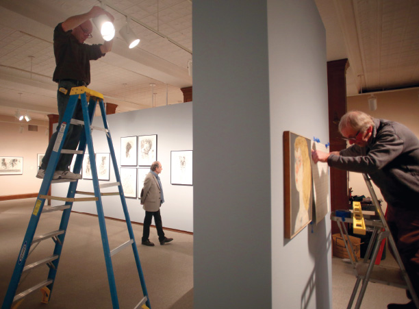 Members of the Holy Cross community assemble the exhibit “Robert Beauchamp: Four Decades of Works on Paper.”