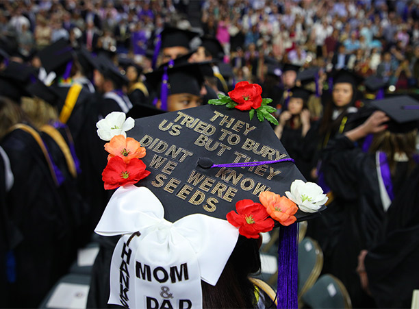 A student wears a decorated mortarboard.