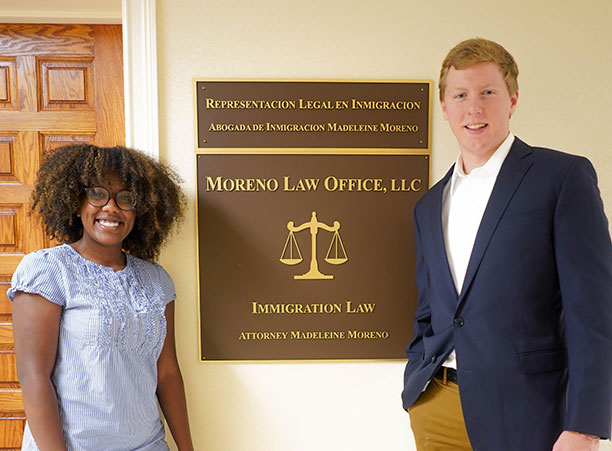 Two students stand outside a law office