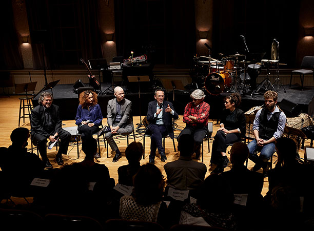 A group of people sit on stage