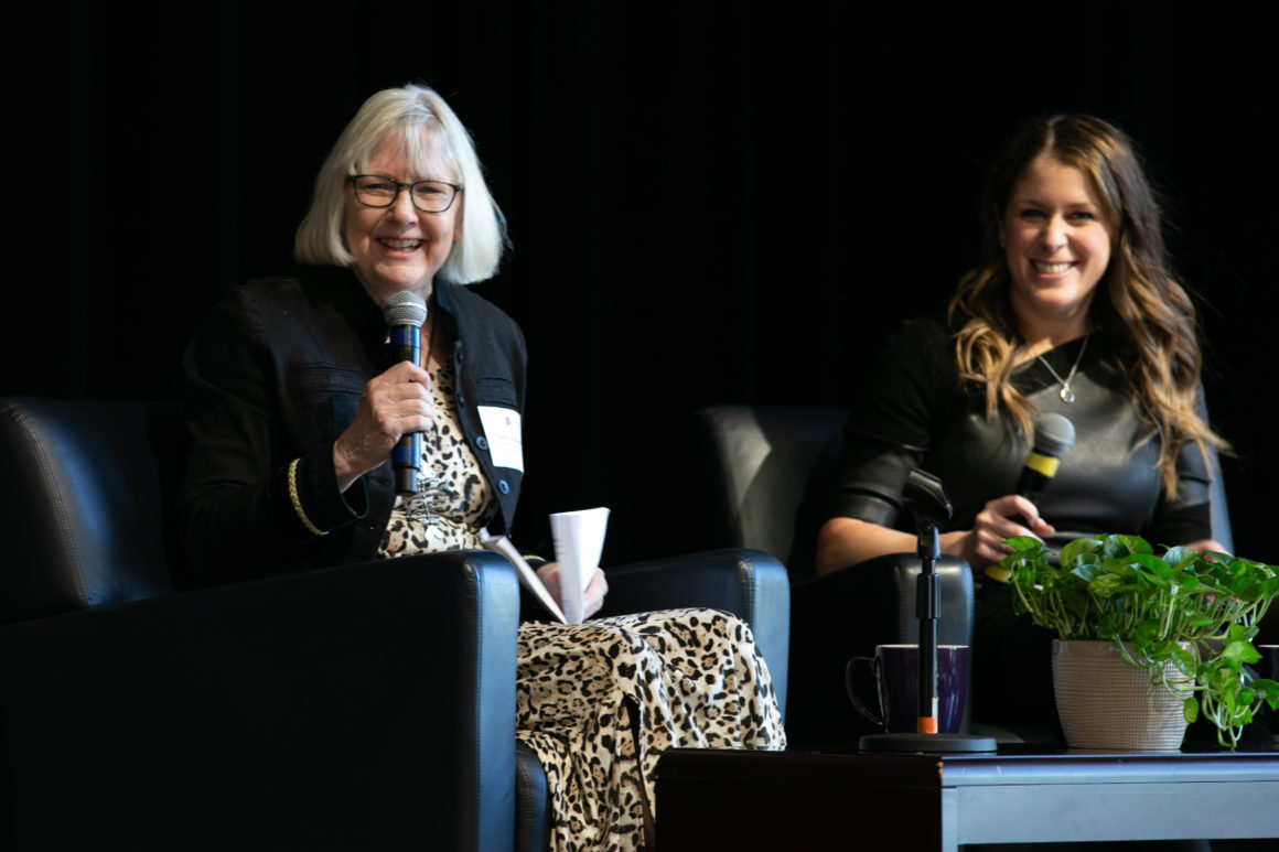 Two women in stage laughing
