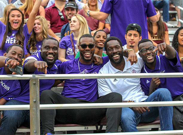 Holy Cross fans laugh at camera in the stands