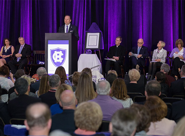 Nate Pine, director of athletics at Holy Cross, speaks during the dedication celebrations.