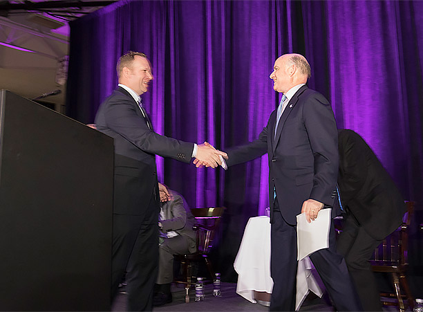 Nate Pine, director of athletics, shakes the hand of John Luth ’74, who alongside his wife, Joanne Chouinard-Luth, made a substantial gift of $32.5 million for the renovation and expansion of the Hart Center at the Luth Athletic Complex..