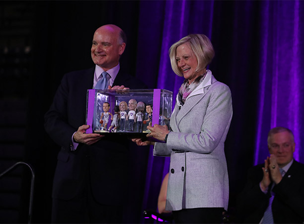 John Luth ’74 and Joanne Chouinard-Luth hold bobbleheads of themselves and other famous Holy Cross alumni — a gift presented to them during the dedication ceremonies.