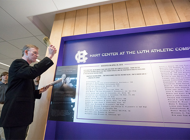 Rev. Philip L. Boroughs, S.J., president of the College, blesses the plaque featured the names of the donors who contributed to the Hart Center at the Luth Athletic Complex.
