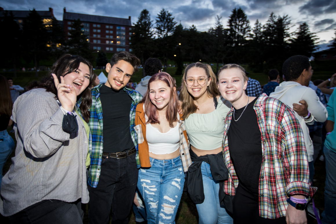 Students pose together for a photo at a campus concert.