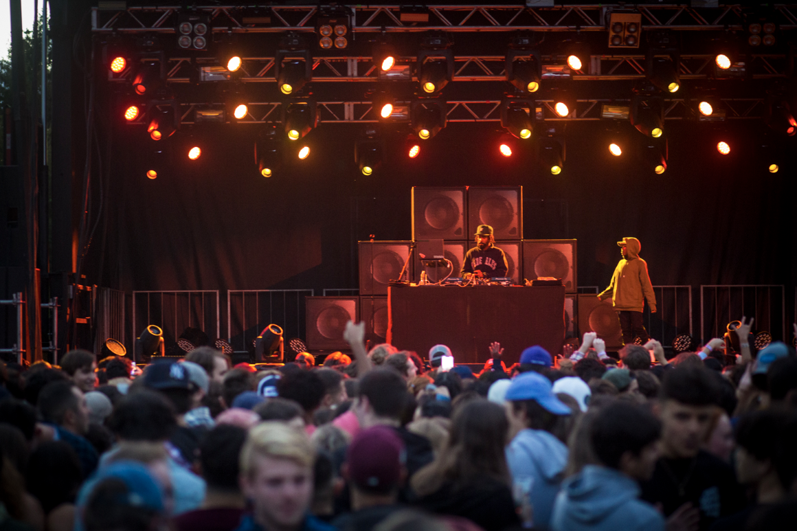 A DJ performs at a campus concert.
