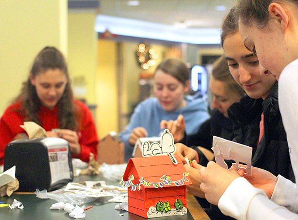 Students take part in the annual Hogan After Dark Christmas event, enjoying holiday tunes and building festive gingerbread houses.