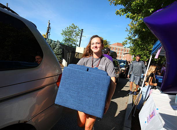 a student carries a box