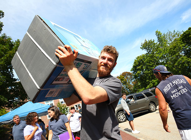 a student lifts a box