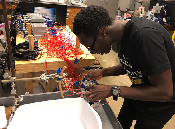 A student works with wires in a lab