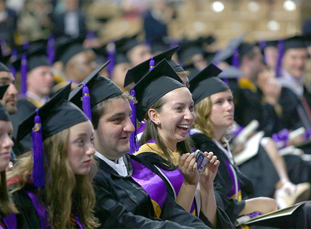 A student celebrates receiving their diploma.