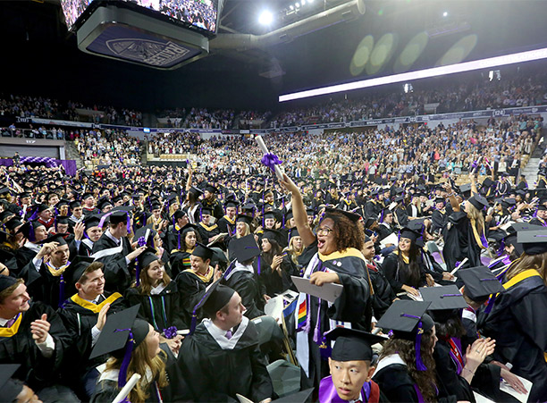 A student celebrates receiving their diploma.