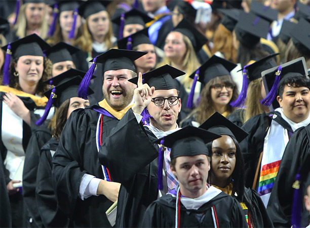 Students celebrate on their way to receive their diplomas.