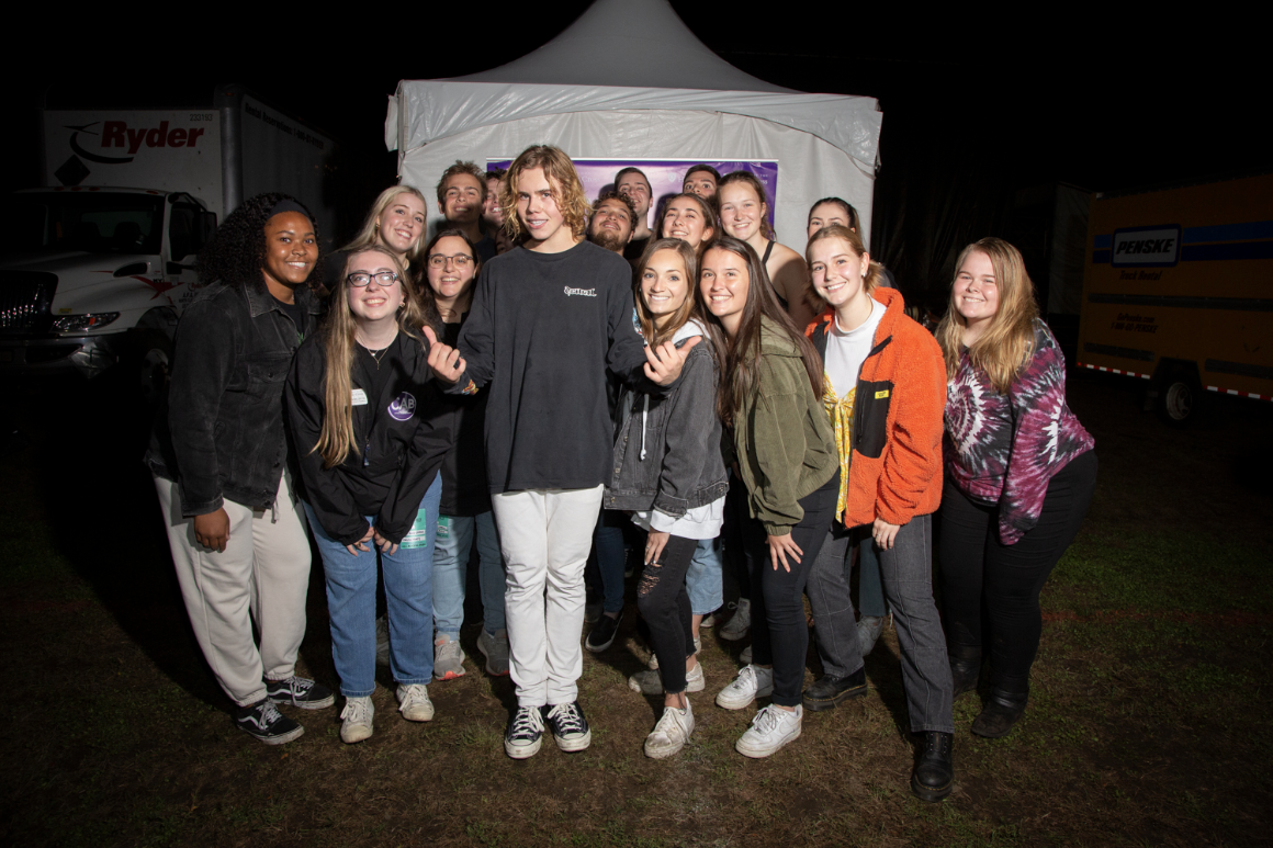 Students pose with the concert performer.