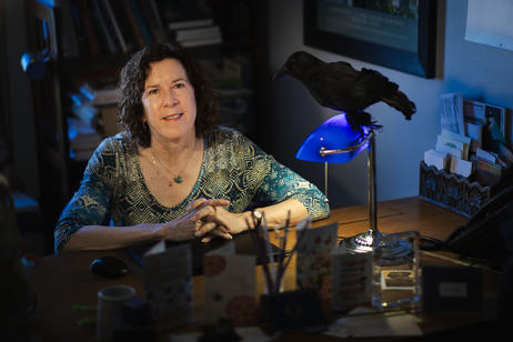 Moody portrait of a literature professor sitting at her desk