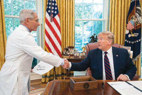 Fauci shaking hands with President Donald Trump in the Oval Office after signing an executive order for flu vaccines in September 2019.