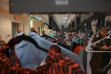 Racks of clothing at a thrift store.