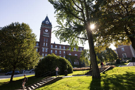Students walk down stairs with O'Kane tower in background