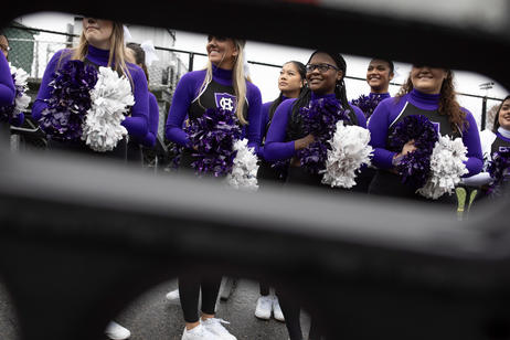 A college football cheer team waiting for the team