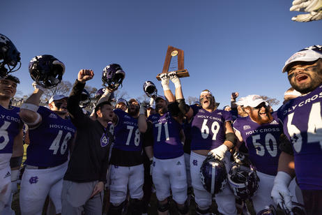 Football players hoist a trophy after winning a league title