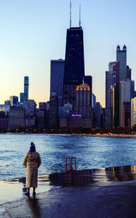 Man in robe faces city skyline
