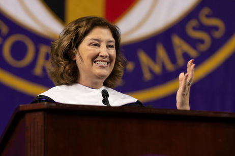 A woman NASA scientist smiles at an audience while she delivers a commencement address.