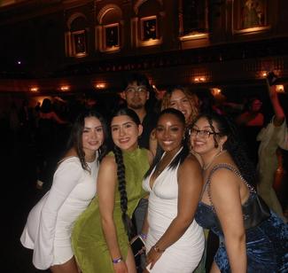 A photos of young people posing for a picture in dresses at the 100 days ball