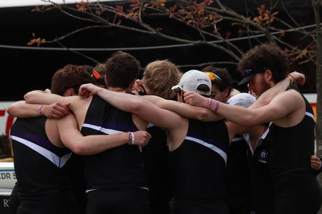 A group of men from the Holy Cross rowing team embrace