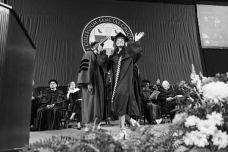 A student reacts after receiving a diploma