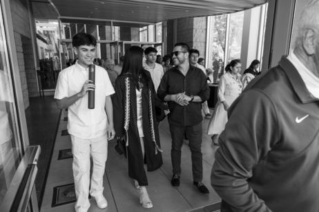 A family walks out of the building after college graduation.