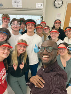 André Isaacs taking a selfie with a group of his chemistry students