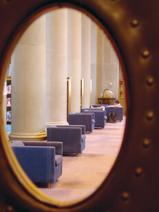 Chairs viewed through an oval window